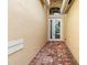Inviting front entrance featuring a double door entry, brick flooring, and decorative archway at 4917 Sandy Brook Crk, Wimauma, FL 33598
