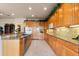 Gourmet kitchen with wooden cabinetry, granite countertops, stainless appliances, and ample counterspace at 4917 Sandy Brook Crk, Wimauma, FL 33598