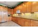 Beautiful kitchen with wooden cabinetry, granite countertops, and stainless steel appliances at 4917 Sandy Brook Crk, Wimauma, FL 33598