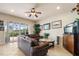 Living room with leather sofa, coffee table, tile floors, and sliding glass doors at 4917 Sandy Brook Crk, Wimauma, FL 33598