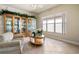 Living room with arm chair, display cabinet, tile floor, and bright window at 4917 Sandy Brook Crk, Wimauma, FL 33598