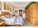 Main bedroom with tray ceiling, king bed, wood floors, and ensuite bathroom at 4917 Sandy Brook Crk, Wimauma, FL 33598