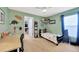bedroom with dinosaur decor, shelving, and a desk at 5212 Twin Creeks Dr, Valrico, FL 33596