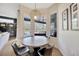 Bright breakfast nook features a round table, stylish lighting, and views of the pool at 5212 Twin Creeks Dr, Valrico, FL 33596