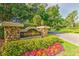 Welcoming community entrance sign amidst lush landscaping and a tree-lined street at 5212 Twin Creeks Dr, Valrico, FL 33596