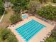 Aerial view of a large, outdoor swimming pool, a kiddie pool, and many lounge chairs at 5212 Twin Creeks Dr, Valrico, FL 33596