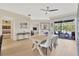 Inviting dining area with ample seating, neutral decor, and sliding glass doors to the outdoor patio at 5212 Twin Creeks Dr, Valrico, FL 33596