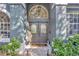 Inviting entryway featuring a double door with decorative windows and manicured landscaping at 5212 Twin Creeks Dr, Valrico, FL 33596