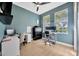 Bright home office featuring two desks, filing cabinet, and large windows that bring in natural light at 5212 Twin Creeks Dr, Valrico, FL 33596