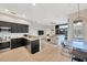 Modern kitchen flowing into the living area, featuring stainless steel appliances at 5212 Twin Creeks Dr, Valrico, FL 33596
