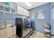 Well-organized laundry room with modern washer and dryer, storage cabinets and utility sink at 5212 Twin Creeks Dr, Valrico, FL 33596