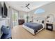 Serene main bedroom with ensuite bathroom and large window at 5212 Twin Creeks Dr, Valrico, FL 33596