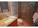 Bathroom with walk in shower, granite counters and sink with a decorative mirror at 5348 Saddlebrook Way # 2, Wesley Chapel, FL 33543