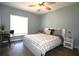 Cozy bedroom with a window, ceiling fan, desk and chair for working, and a night stand at 5348 Saddlebrook Way # 2, Wesley Chapel, FL 33543