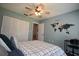 Comfortable bedroom features a ceiling fan and world map wall decor and large closet at 5348 Saddlebrook Way # 2, Wesley Chapel, FL 33543