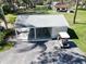 Carport and golf cart parking, surrounded by lush greenery and a paved driveway at 5348 Saddlebrook Way # 2, Wesley Chapel, FL 33543