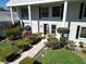 Inviting entrance with manicured bushes leading up to the front door at 5348 Saddlebrook Way # 2, Wesley Chapel, FL 33543