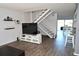 Bright living room featuring modern décor, laminate floors, and a staircase at 5348 Saddlebrook Way # 2, Wesley Chapel, FL 33543