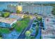 Scenic aerial view of the condominium complex with stunning water views and nearby city skyline at 55 Harbor View Ln # 108, Belleair Bluffs, FL 33770