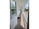 Condo balcony with stone pavers, white railing and an exterior door to unit at 55 Harbor View Ln # 108, Belleair Bluffs, FL 33770