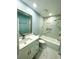 Modern bathroom featuring a white vanity, a large mirror, marble-look tile, and a shower-tub combination at 55 Harbor View Ln # 108, Belleair Bluffs, FL 33770