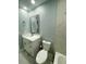 Bathroom features a vanity with modern fixtures, toilet, and a marble-look tile in the shower area at 55 Harbor View Ln # 108, Belleair Bluffs, FL 33770