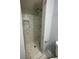 Bathroom showing a modern shower with marble-look tile and a convenient recessed shelf at 55 Harbor View Ln # 108, Belleair Bluffs, FL 33770