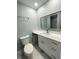 Bathroom features a vanity, toilet, and a mirror above the sink at 55 Harbor View Ln # 108, Belleair Bluffs, FL 33770