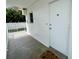 Condo entryway featuring concrete pavers, white trim, and door to unit at 55 Harbor View Ln # 108, Belleair Bluffs, FL 33770