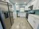 Modern kitchen with stainless steel appliances and white cabinets at 55 Harbor View Ln # 108, Belleair Bluffs, FL 33770
