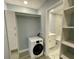 Convenient laundry room featuring a washer, storage cabinets, and access to a bathroom for added functionality at 55 Harbor View Ln # 108, Belleair Bluffs, FL 33770