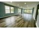 Spacious living room featuring light blue walls, modern gray flooring, and ample natural light through multiple windows at 55 Harbor View Ln # 108, Belleair Bluffs, FL 33770