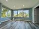Bright living room featuring blue walls, modern flooring, recessed lighting and a large window with a serene view at 55 Harbor View Ln # 108, Belleair Bluffs, FL 33770