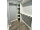 Organized walk-in closet with custom shelves at 55 Harbor View Ln # 108, Belleair Bluffs, FL 33770