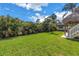 View of backyard with the outdoor shed, tiki hut, and lush landscaping at 6630 Gulfport S Blvd, South Pasadena, FL 33707