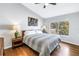 Bright bedroom featuring hardwood floors, a large window, and accent lamps at 6630 Gulfport S Blvd, South Pasadena, FL 33707