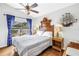 Cozy bedroom with unique decor, bedside tables and sliding glass door to deck at 6630 Gulfport S Blvd, South Pasadena, FL 33707