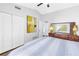 Bright bedroom featuring hardwood floors, closet and dresser at 6630 Gulfport S Blvd, South Pasadena, FL 33707