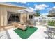 Outdoor deck with patio furniture and striped umbrella at 6630 Gulfport S Blvd, South Pasadena, FL 33707