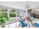 Bright dining room featuring an elegant light fixture, table and chairs, and views of the outdoor area at 6630 Gulfport S Blvd, South Pasadena, FL 33707