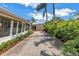 Driveway leads to detached garage and features lush landscaping and covered porch at 6630 Gulfport S Blvd, South Pasadena, FL 33707