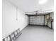 Clean, unfinished garage featuring a central vacuum, storage, and a roll-up garage door at 6630 Gulfport S Blvd, South Pasadena, FL 33707