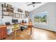 Bright home office with hardwood floors, open shelves, a ceiling fan, and a large window with leafy green views at 6630 Gulfport S Blvd, South Pasadena, FL 33707