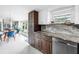 Modern kitchen showcasing granite countertops, sleek appliances, and a bright dining area with outdoor views at 6630 Gulfport S Blvd, South Pasadena, FL 33707