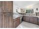Well-equipped kitchen featuring custom cabinets, granite countertops, and stainless steel appliances at 6630 Gulfport S Blvd, South Pasadena, FL 33707
