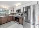 Modern kitchen featuring stainless steel appliances, two-tone cabinets, and granite countertops at 6630 Gulfport S Blvd, South Pasadena, FL 33707