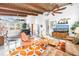 Spacious living room boasting exposed beam ceilings, contemporary furniture, and an open layout, perfect for entertaining at 6630 Gulfport S Blvd, South Pasadena, FL 33707