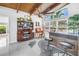 Bright living room featuring high ceilings, a bar area, a china cabinet, and an abundance of natural light at 6630 Gulfport S Blvd, South Pasadena, FL 33707