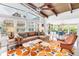 Airy living room with a vaulted wood ceiling, ample natural light, and an open layout to the dining area at 6630 Gulfport S Blvd, South Pasadena, FL 33707