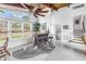 Stylish living room with high ceilings, wooden beams, bar, and large windows offering natural light at 6630 Gulfport S Blvd, South Pasadena, FL 33707